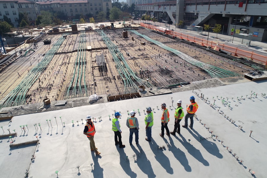 Construction crew overlooking rebar and utility conduit on a public site